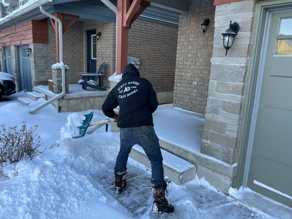 Ainger snow shoveling service clearing a residential walkway in Collingwood Ontario