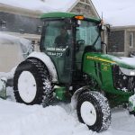 Powered snow blower equipment clearing snow at a residential property in Collingwood Ontario robot