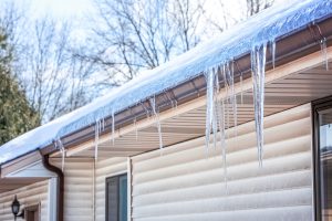 Snow and ice buildup along a residential roof edge in Collingwood Ontario